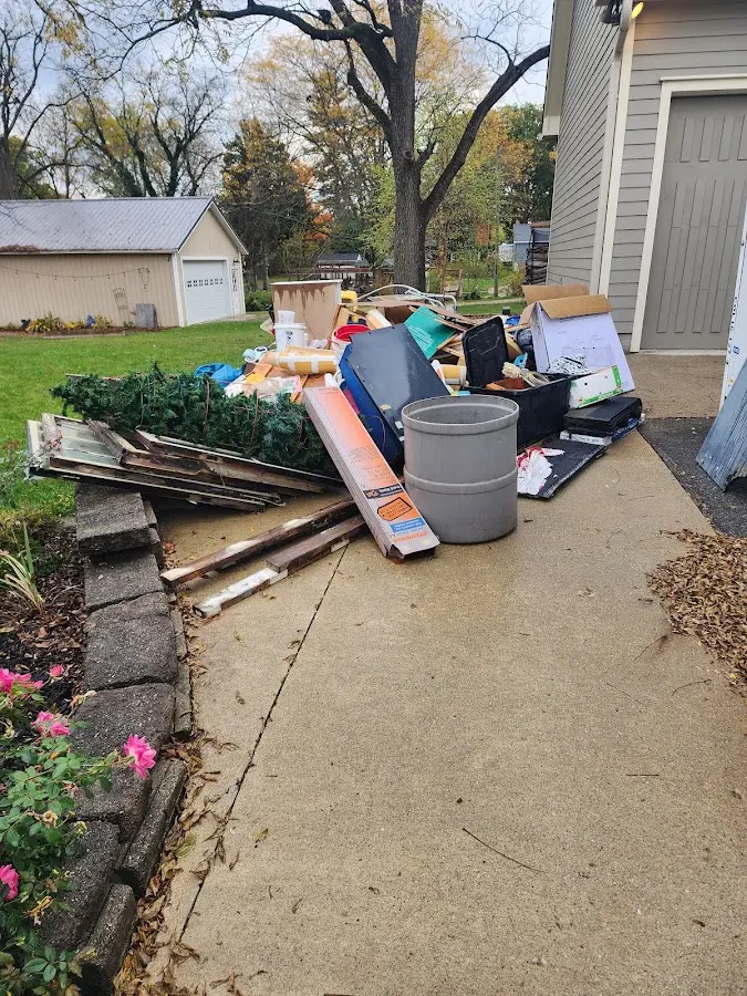 Dumpster being loaded with debris for Estate Cleanout Dumpster Rental in Terre Haute